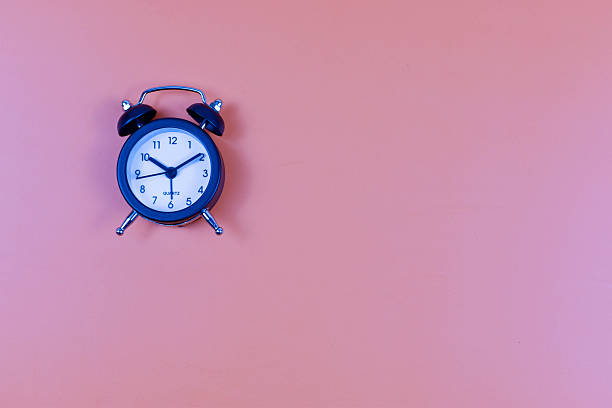 istock Analog alarm clock on pink background emphasizes time awareness, punctuality, and the visual impact of minimalist design. 2246921422