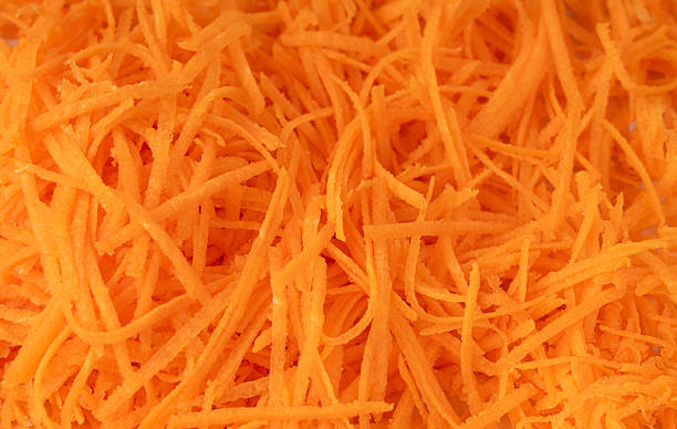 istock Fresh Finely Grated Carrots Textured Background, Raw Carrot Pieces Closeup Pattern 2246921770