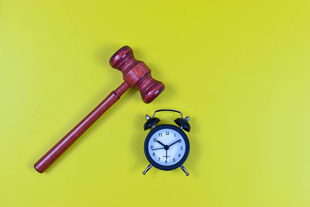 istock Judge's gavel and alarm clock on yellow background 2246922001