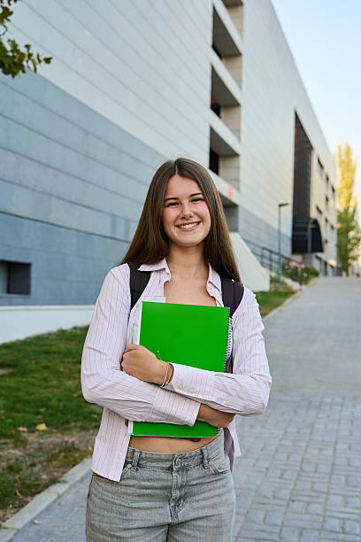istock Young female student smiling on university campus 2246926527