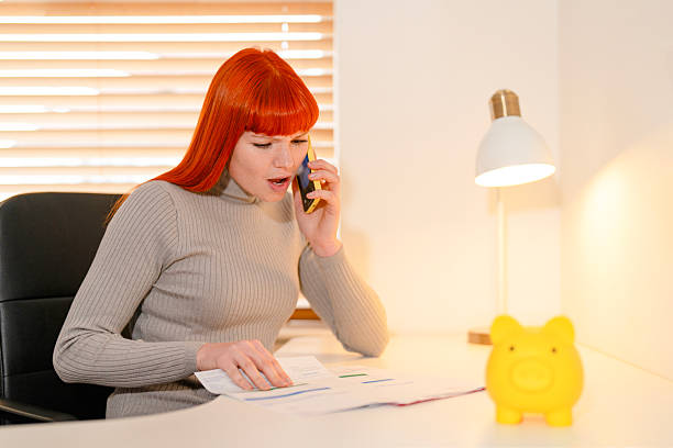 istock Businesswoman discussing finances while managing paperwork at home office 2246926574