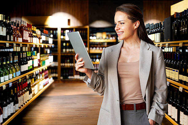 istock Female professional using digital tablet on background of wine shop. 2246927365