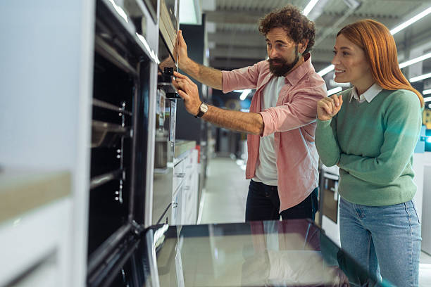 istock Enthusiastic couple is thrilled to be taking advantage of deep discounts on high-end kitchen appliances during the Black Friday shopping season. They are inspecting the features of an oven or stove 2246929090