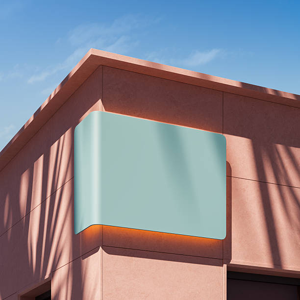 istock Blank light blue signage mockup on modern pink building corner under clear blue sky with shadows and sunlight on wall surface during daytime. 3D Rendering 2246931569