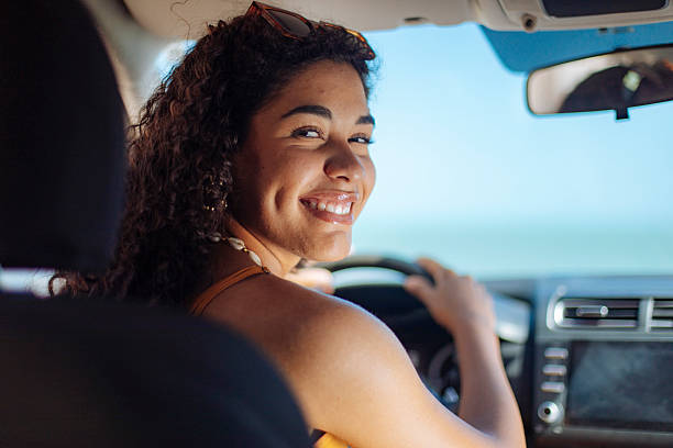 istock Smiling young woman driving on a sunny day 2246932848