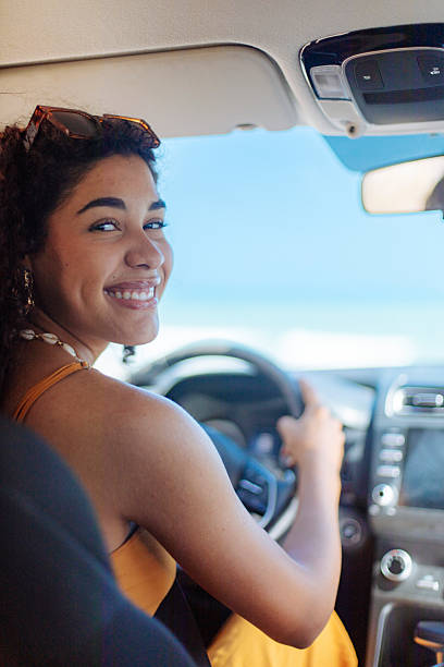 istock Smiling young woman driving on a sunny day 2246933100