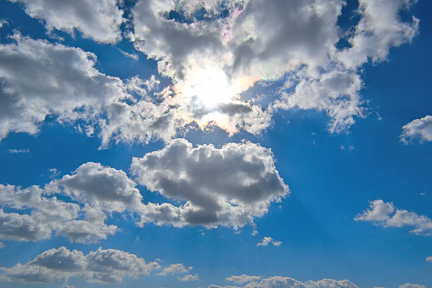 The sunlight reflected through the clouds of blue sky