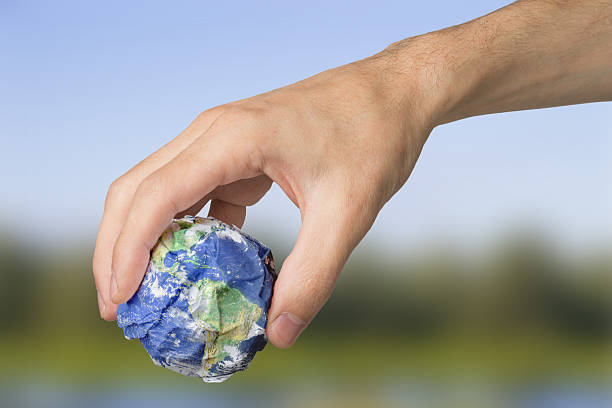 istock Planet Earth in the hands of garbage pollution ecology 2246935346