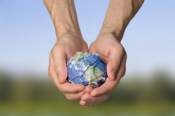 istock Planet Earth in the hands of garbage pollution ecology 2246935360