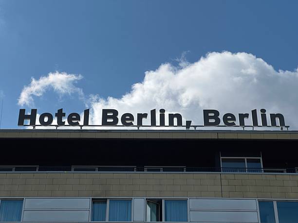 Berlin, Germany, September 6, 2025 - Building facade with large rooftop sign reading “Hotel Berlin, Berlin” against a blue sky with clouds