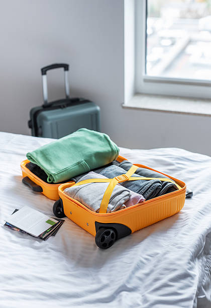 istock Open suitcase filled with clothes packing for travel 2246942310