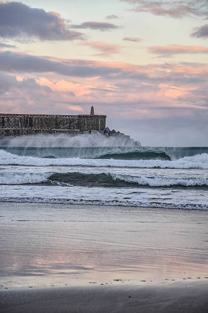istock Wave in front of the lighthouse during sunrise on the beach in Orio 2246945892