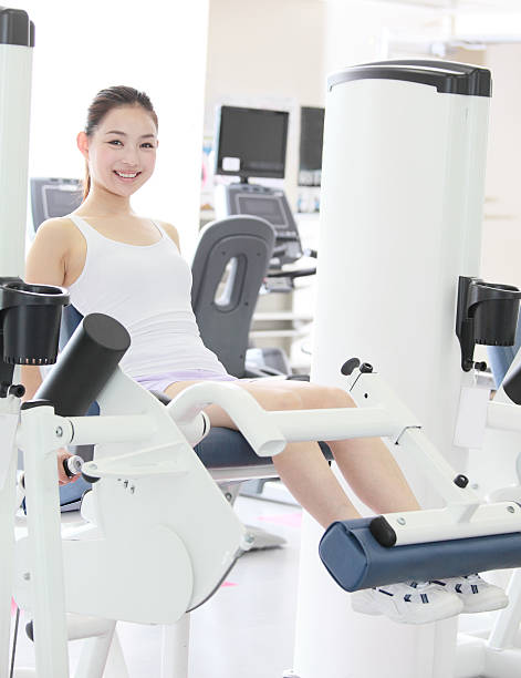 Woman exercising her legs with leg extensions