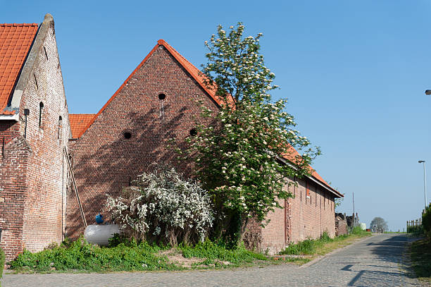 Herzele, Belgium - April 26, 2020. Outdoor scene showing an old barn on a beautiful spring morning in small town in east-flanders, belgium.