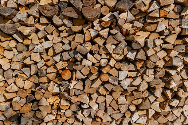 istock Cut stacked firewood neat woodpile texture background rustic winter heating 2246947010