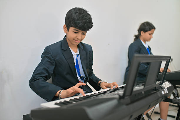 istock Students concentrate on keyboard practice during a school music lesson. 2246950432