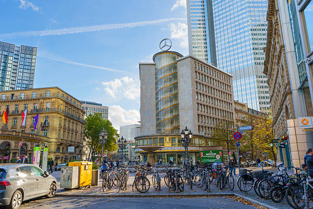 Frankfurt, Germany - October 21, 2025: Lively urban square in Frankfurt, Germany, featuring a dynamic blend of modern high-rises, classic buildings, and numerous parked bicycles.