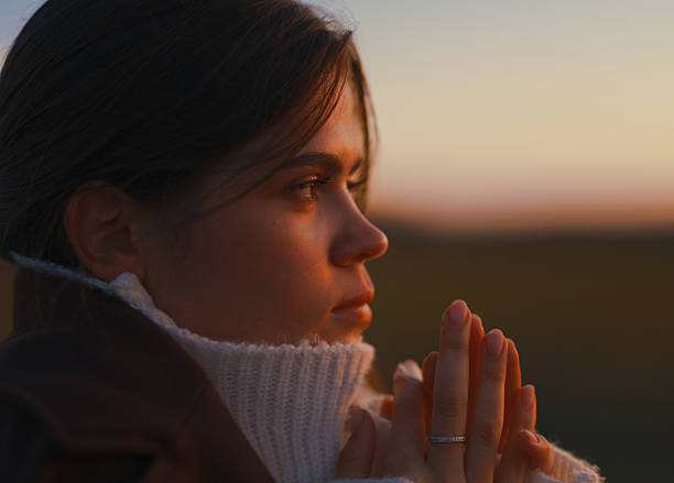 istock Close-Up Woman Face Profile and Hands Sunset Light 2246954805