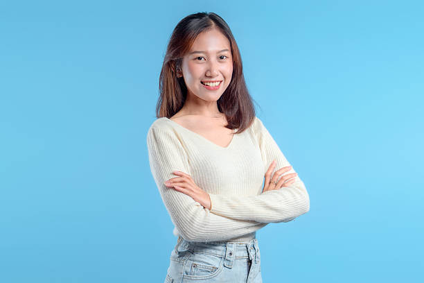 istock Smiling Indonesian Woman with Confident Pose on Blue Background 2246959605