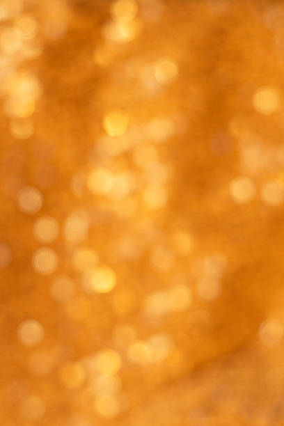Soft, glowing golden bokeh creates a luxurious, festive mood ideal for celebrations and branding.