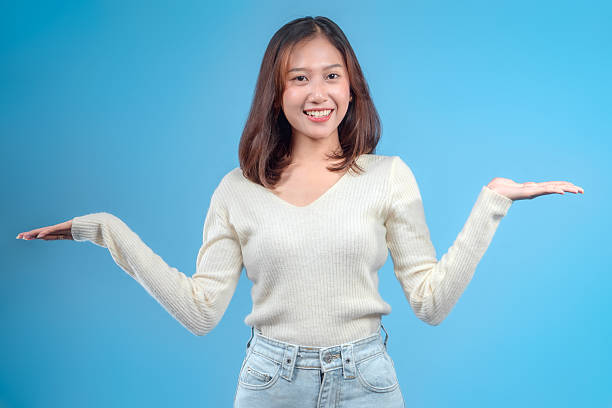 istock Indonesian Woman Smiling with Balanced Open-Hand Gesture 2246960382