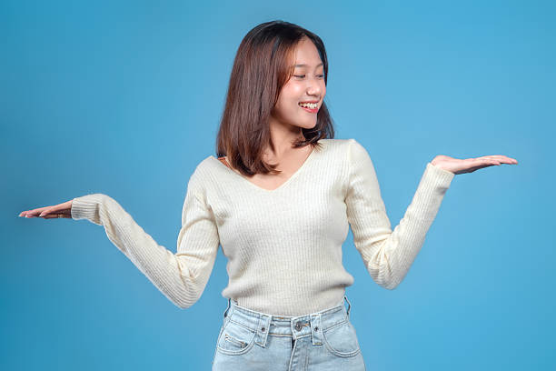 istock Indonesian Woman Smiling with Balanced Presenting Gesture 2246960405
