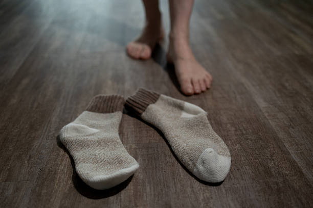 istock Taking off Socks After Enjoying Underfloor Heating at Home 2246960893