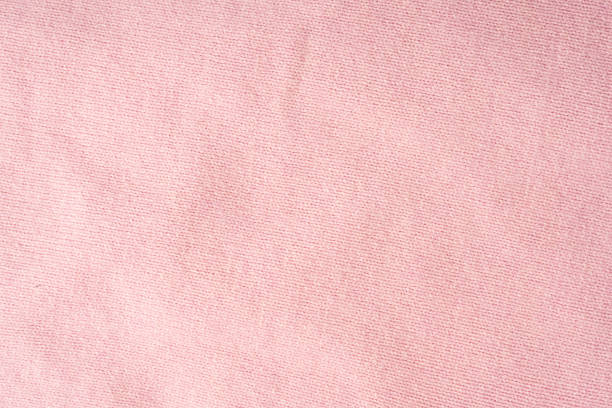 Pink fabric background, top view