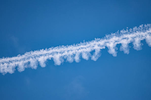Conspiracy Theories symbolic image: Sky with contrails with the words Conspiracy Theories