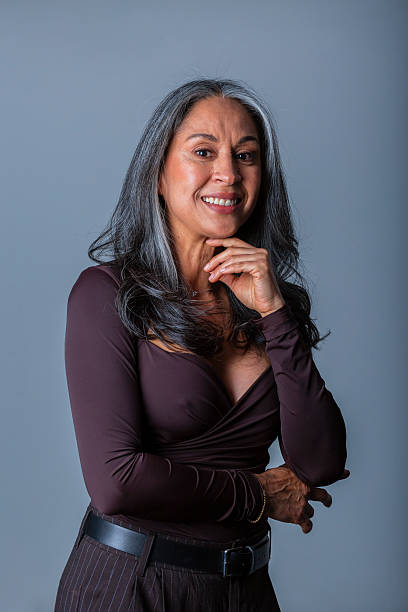 istock Portrait of a woman in a studio, formally dressed 2246965400