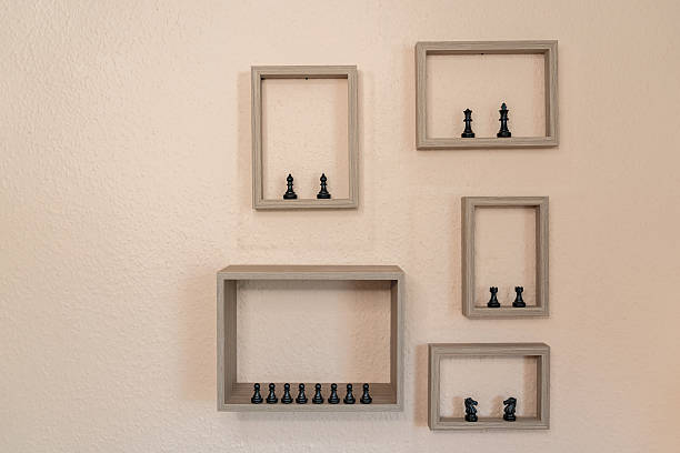 Chess figures in picture frames on the wall