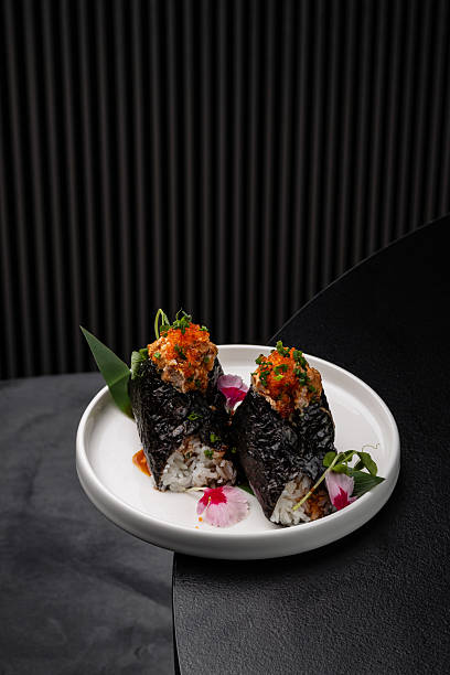 istock Onigiri with fish filling, drizzled with sauce on a white plate isolated for menu 2246971674
