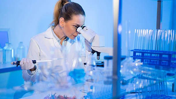 istock Scientist woman researching with microscope in laboratory 2246976637
