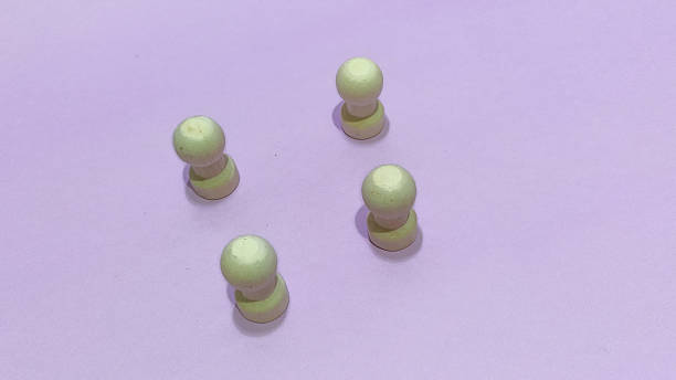 istock Intriguing game strategy unfolds with wooden pawn pieces on pastel purple backdrop, inviting creativity and brainstorming for your next innovative project 2246976811