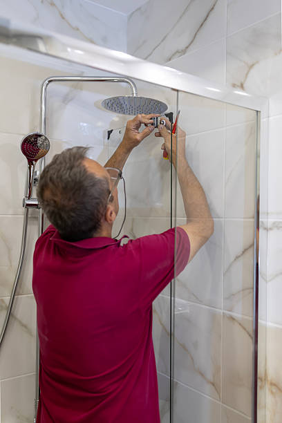 istock Man installing shower door fitting in modern bathroom 2246978006