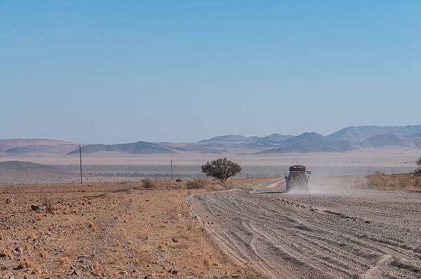 Central Namibia, Namibia - July 11, 2019. Outdoor scene showing an all terrain vehicle crossing the desert in central namibia.