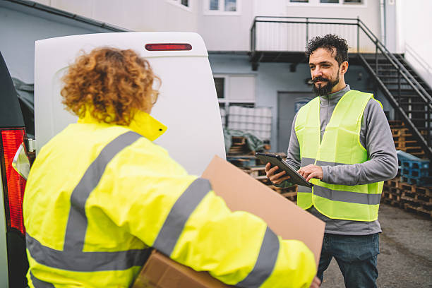 istock Teamwork in Delivery Collaborating to Ensure Package Distribution 2246978617