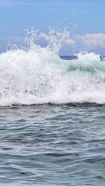 istock Seychelles ocean wave splashing with white water foam 2246979682