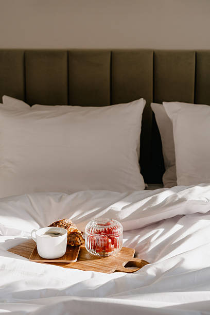 istock Clean and cozy bedroom setup with breakfast tray on soft bedding 2246980148