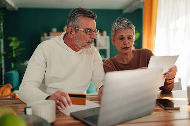 istock Senior couple managing finances and paying bills online 2246982785