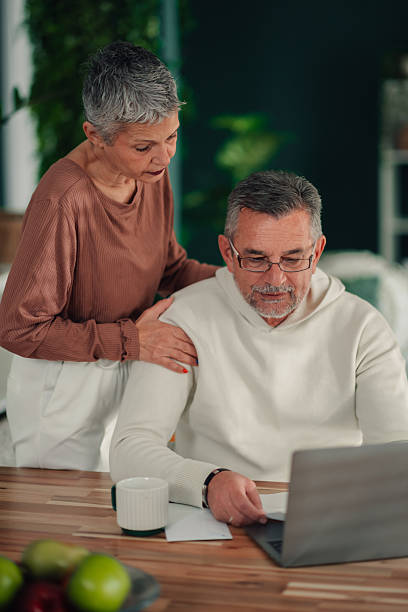 istock Senior couple managing home finance using laptop computer 2246982903