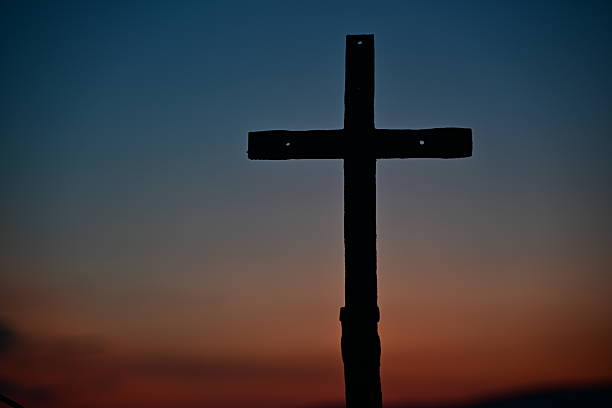 istock Cross Silhouette Against Colorful Sunset Sky 2246983042