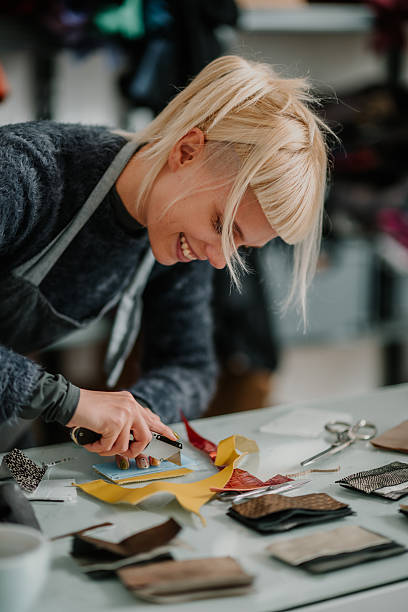 istock Woman crafting leather goods in creative workshop 2246985604