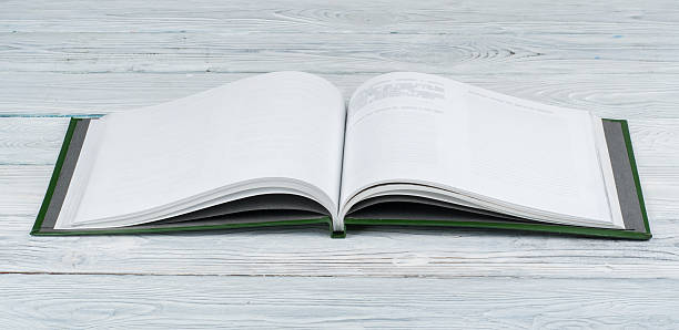 istock Open book on wooden deck table and black board background. Back to School. Education concept with copy space for your ad text. 2246987342