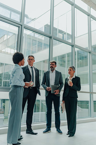 istock Diverse business professionals having informal meeting in office corridor 2246988672