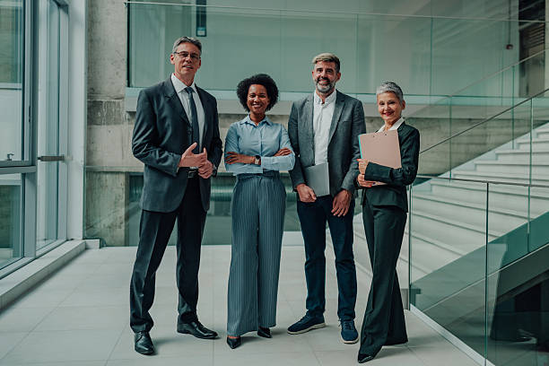 istock Diverse business team smiling in modern office corridor 2246988757