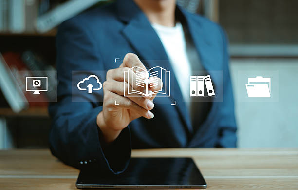 istock E-library and E-learning Concept, Person using laptop with virtual E-Book icons for online knowledge Base, Digital library, Access electronic books on Internet. Course education. Webinar technology. 2246990191