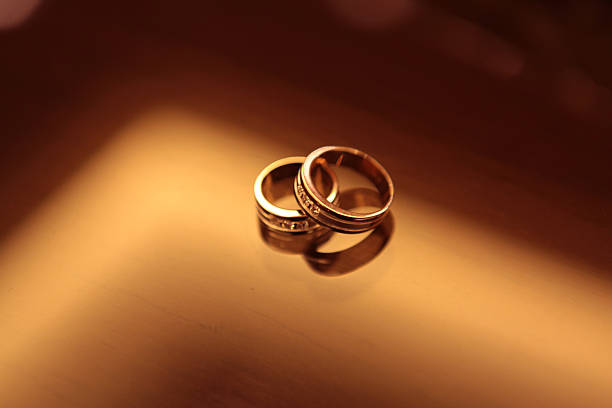 istock Elegant precious Diamond wedding Rings Resting On Surface With Blurred Backdrop For Wedding ceremony 2246990278