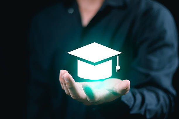 istock Businessman holding graduation hat online learning education student university e-learning technology concept success achievement diploma academic cognition course business cap school training 2246990798