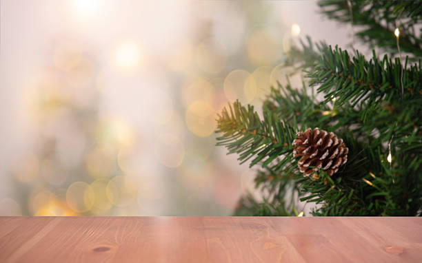 istock Christmas tree branch with pine cone on wooden table foreground creating festive holiday atmosphere for seasonal decoration concepts warm winter celebration themes and cozy Christmas background 2246991522